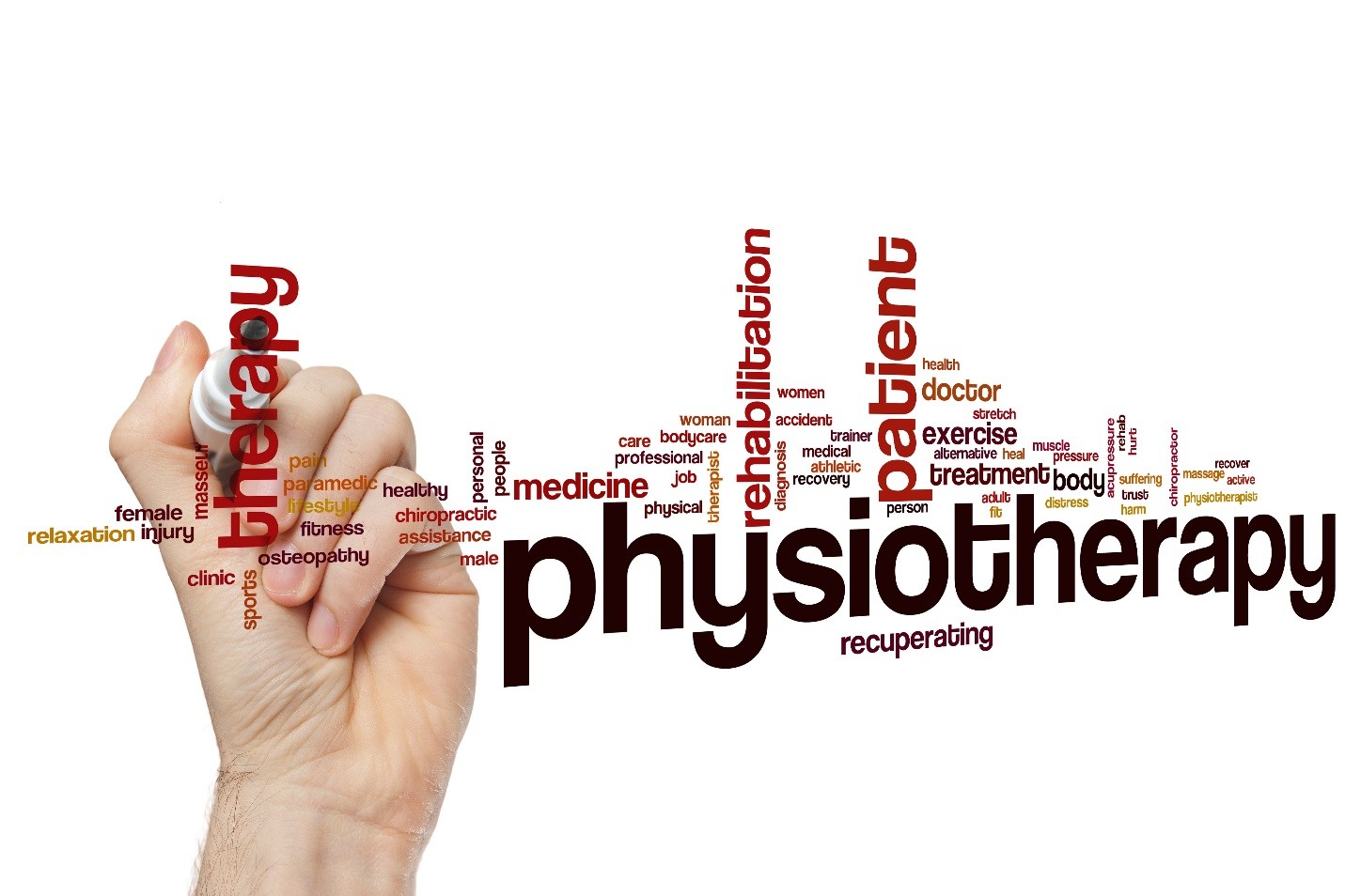 A hand writing the word 'physiotherapy' surrounded by related medical terms like therapy, patient, rehabilitation, medicine, exercise, treatment