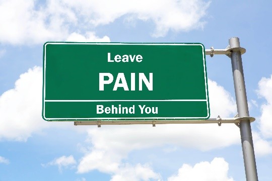 Road sign reading Leave PAIN Behind You against a blue sky