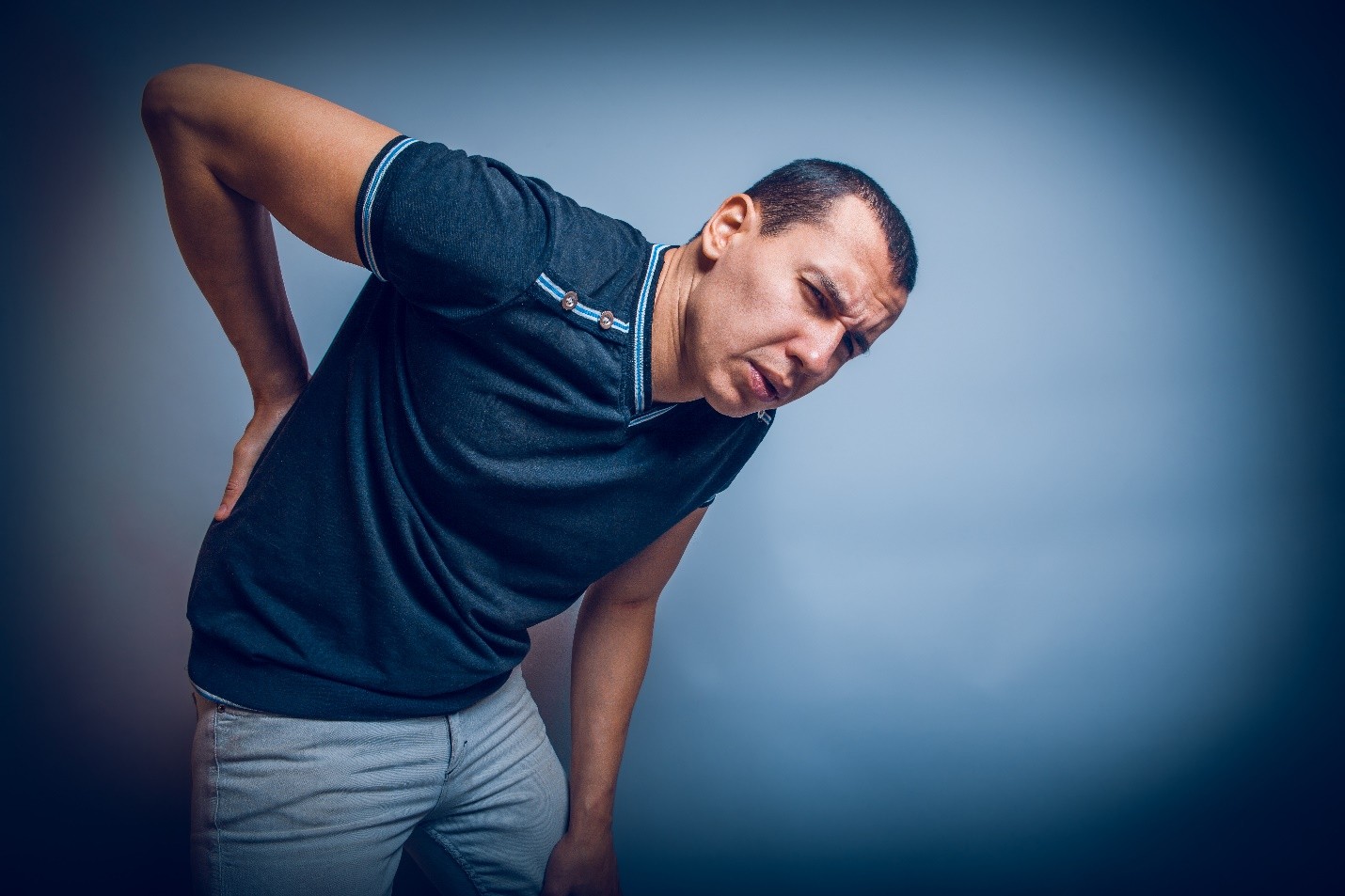 Man holding his lower back in pain