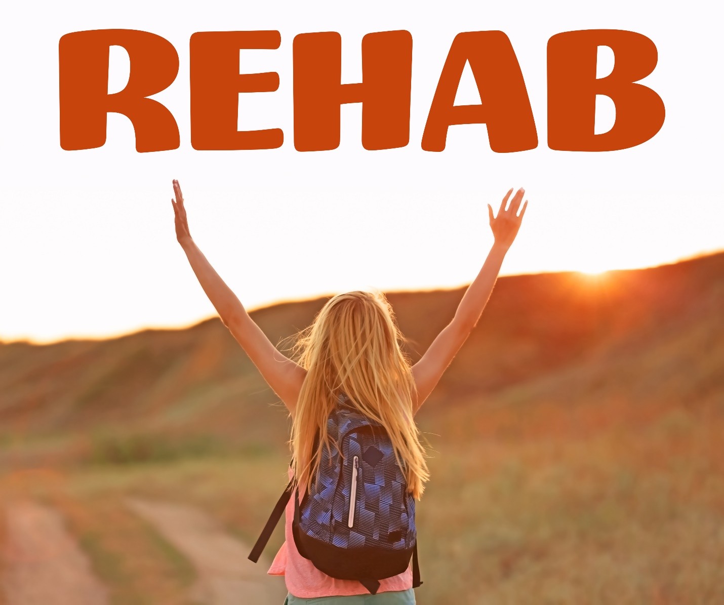 Person with arms raised at sunset with the word REHAB above them