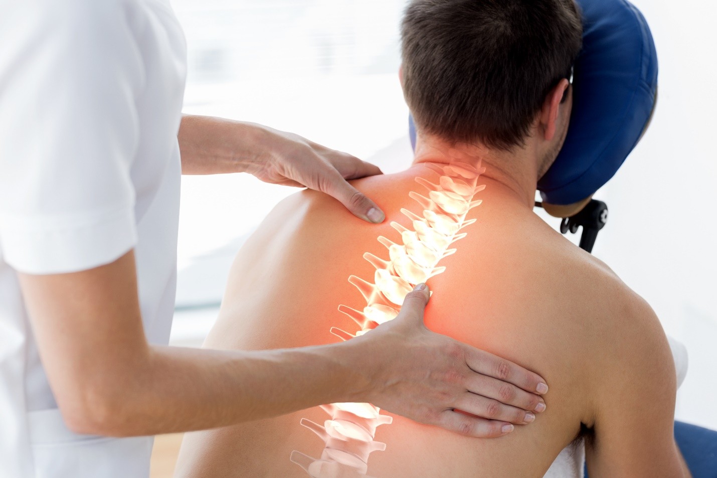 Person receiving a back massage with an overlay of the spine