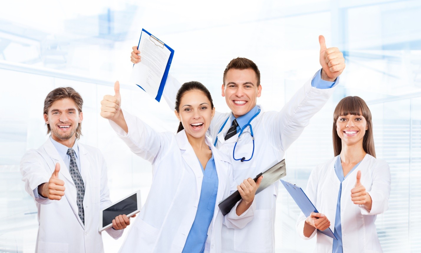 Smiling medical professionals giving thumbs up