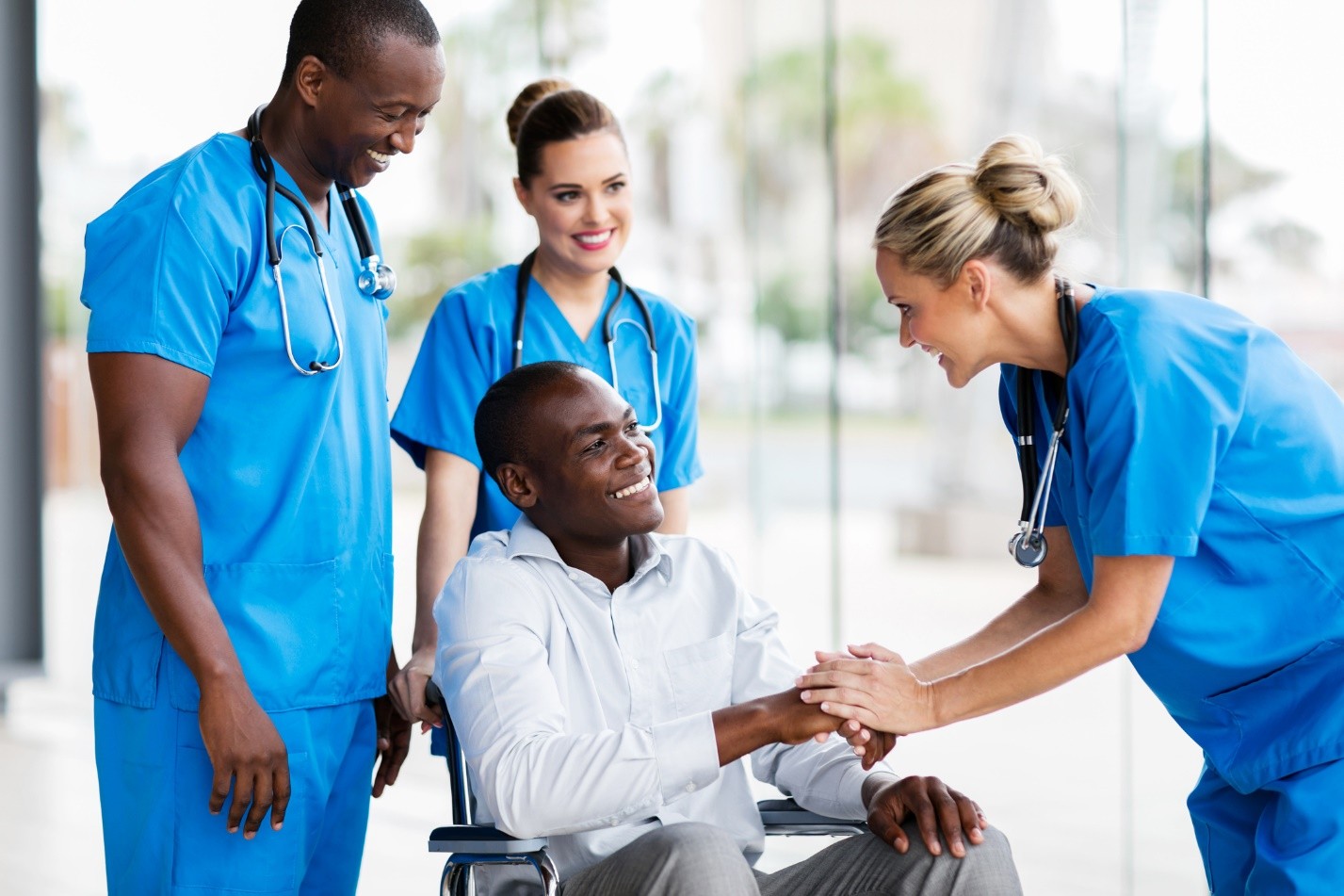 Medical professionals attending to a patient in a wheelchair